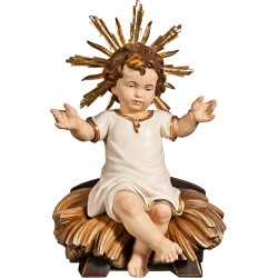 Niño Jesús vestido sentado en cuna